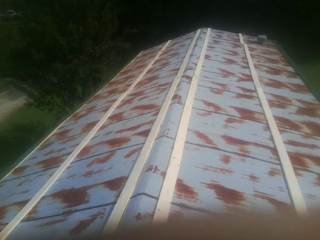 Rusted metal roof panels with new wood purlins before replacement — Storm Damage Roof Repair in Bulger by Roofing Brothers