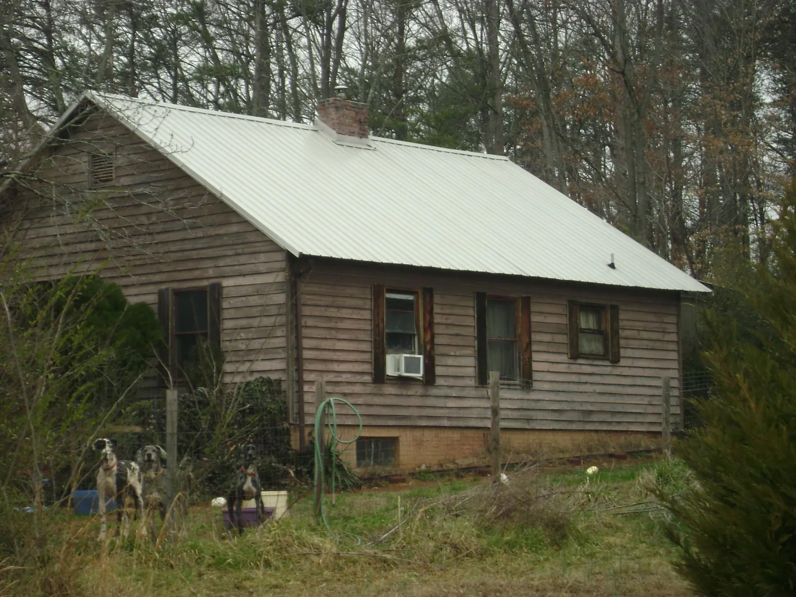 White metal roof on an old wood sided farmhouse, from a Metal Roof Installation job in Bulger